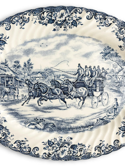 Vintage porcelain platter with blue floral border and horse-drawn carriage scene, collectible tableware