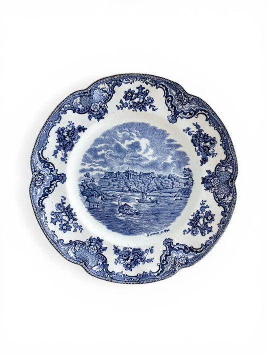 Top-down view of a vintage Johnson Brothers Old Britain Castles blue salad plate featuring Windsor in 1792 on a white background.