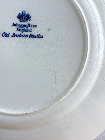 Macro view of authentic glaze crazing and a faint hairline crack on the reverse of a vintage English ironstone plate.
