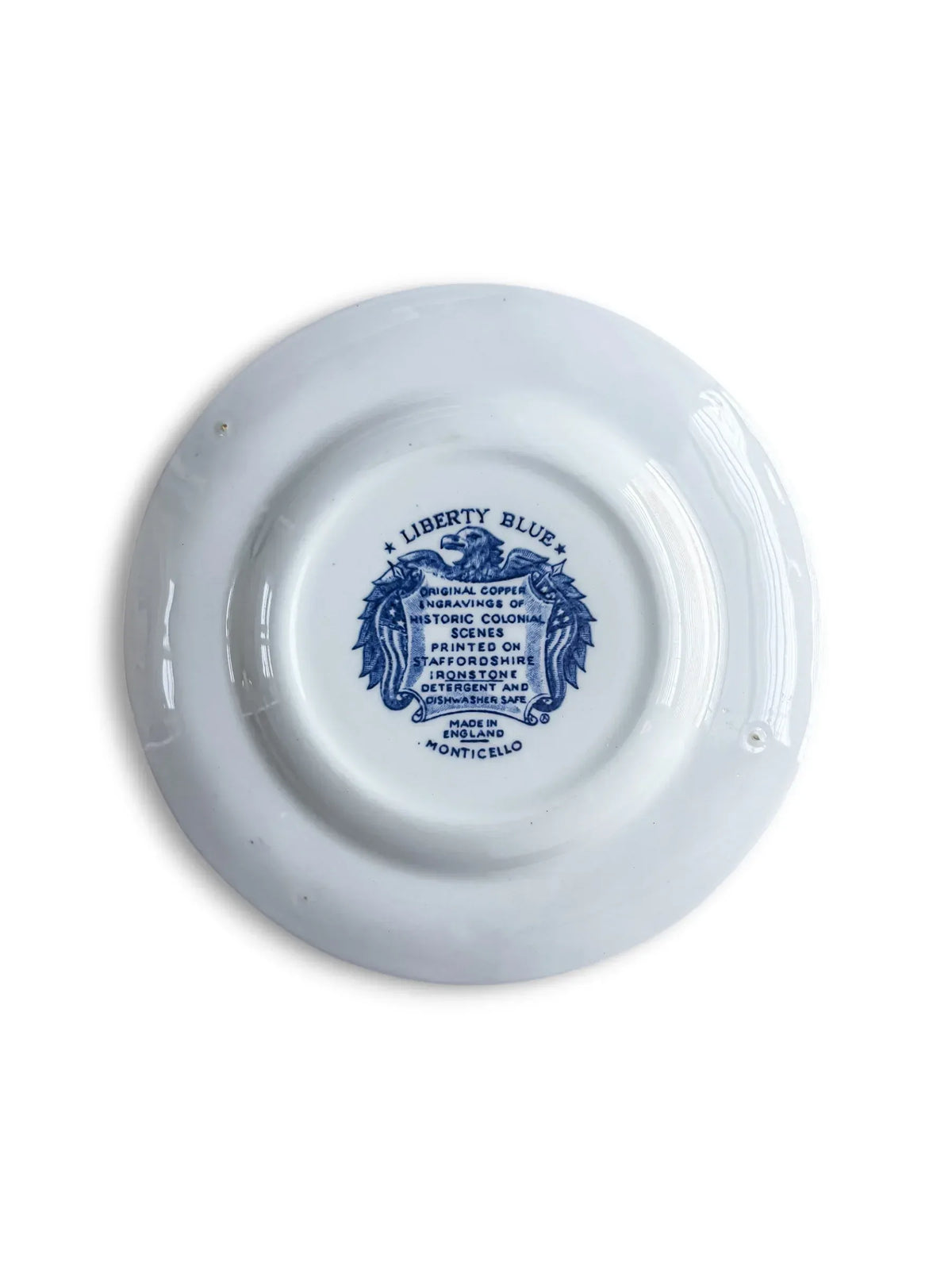 Reverse of the Liberty Blue Monticello bread plate with the original eagle-and-shield backstamp reading Liberty Blue, Staffordshire ironstone, Made in England, Monticello.