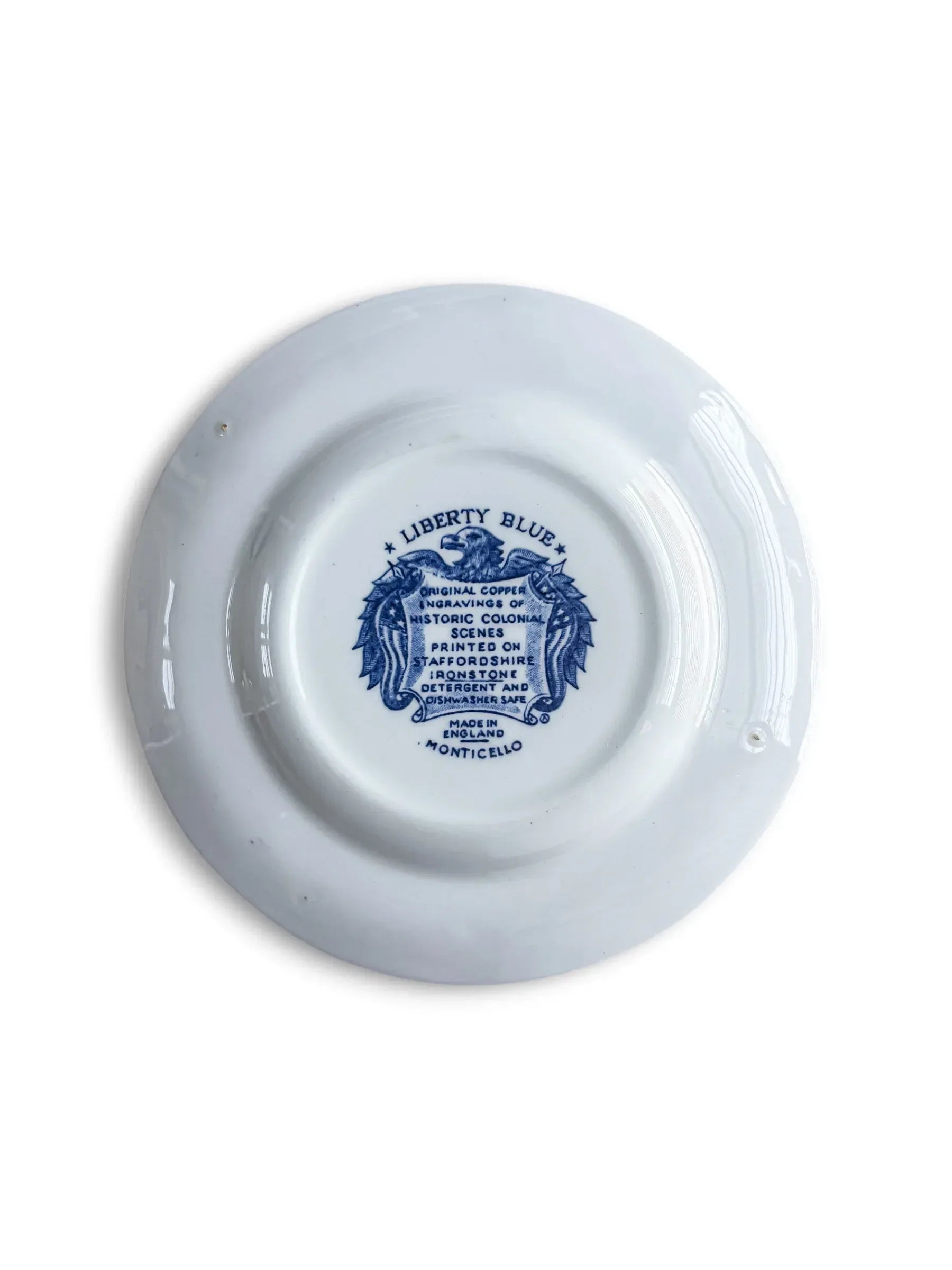 Reverse of the Liberty Blue Monticello bread plate with the original eagle-and-shield backstamp reading Liberty Blue, Staffordshire ironstone, Made in England, Monticello.
