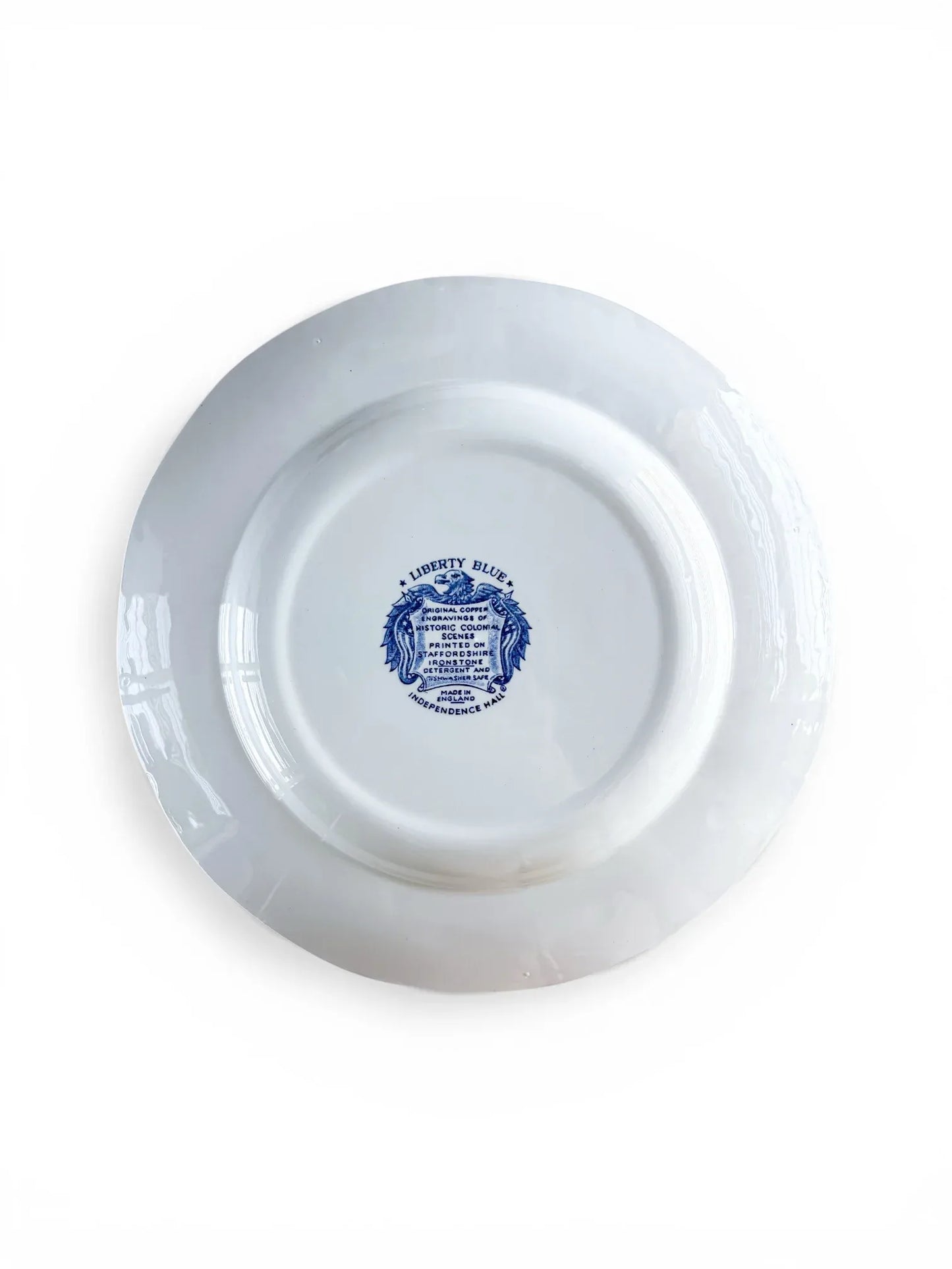 Reverse side of a Liberty Blue ironstone plate showing the clean white base and the central blue eagle and shield backstamp.