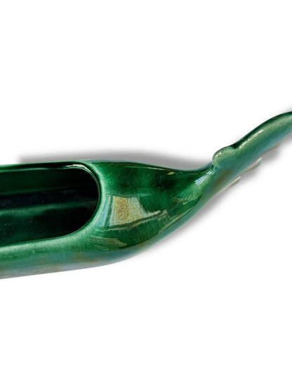 Glossy green ceramic canoe-shaped decorative bowl with textured surface