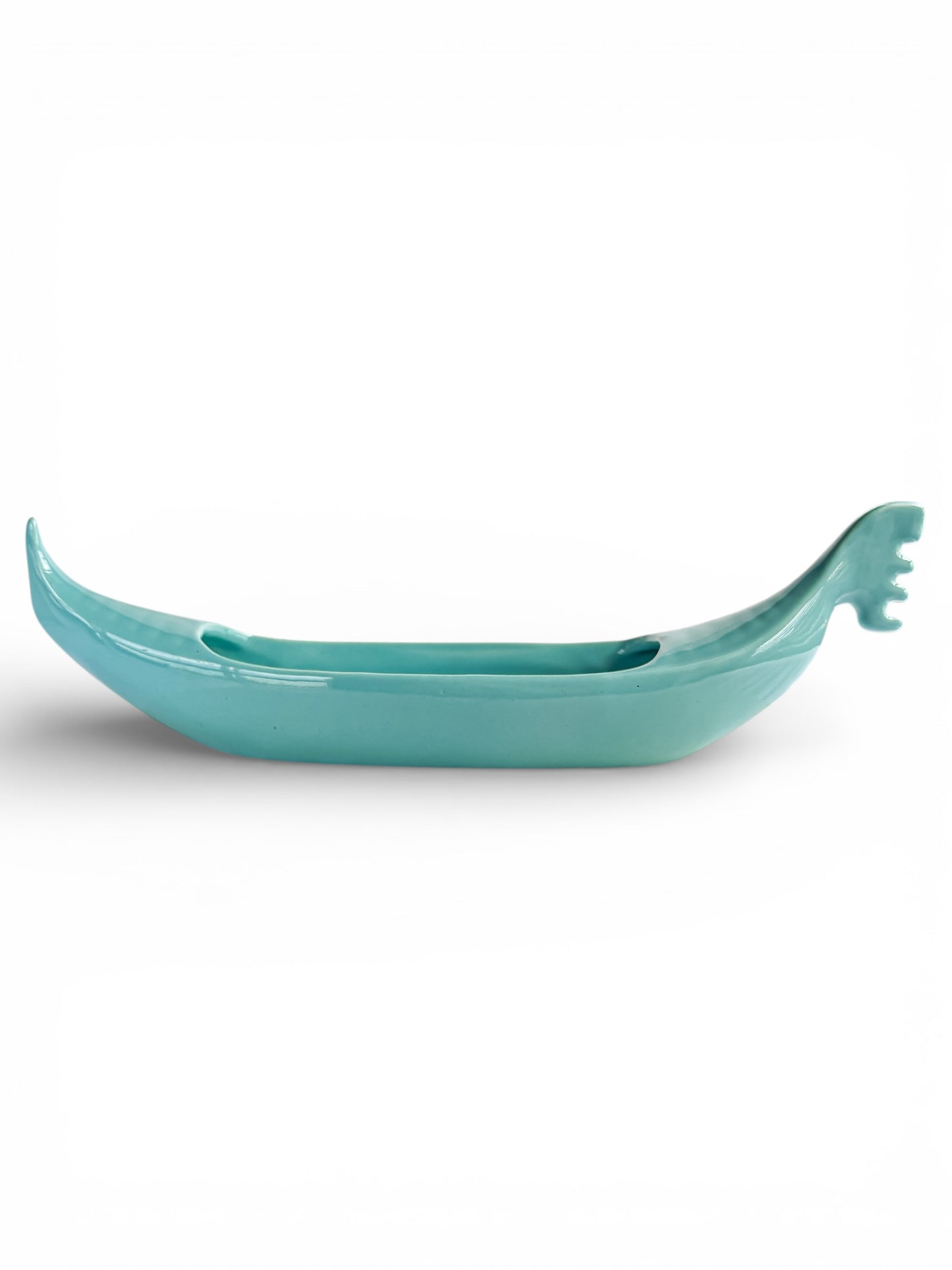 Turquoise ceramic boat-shaped vase on white background, vintage tableware accent