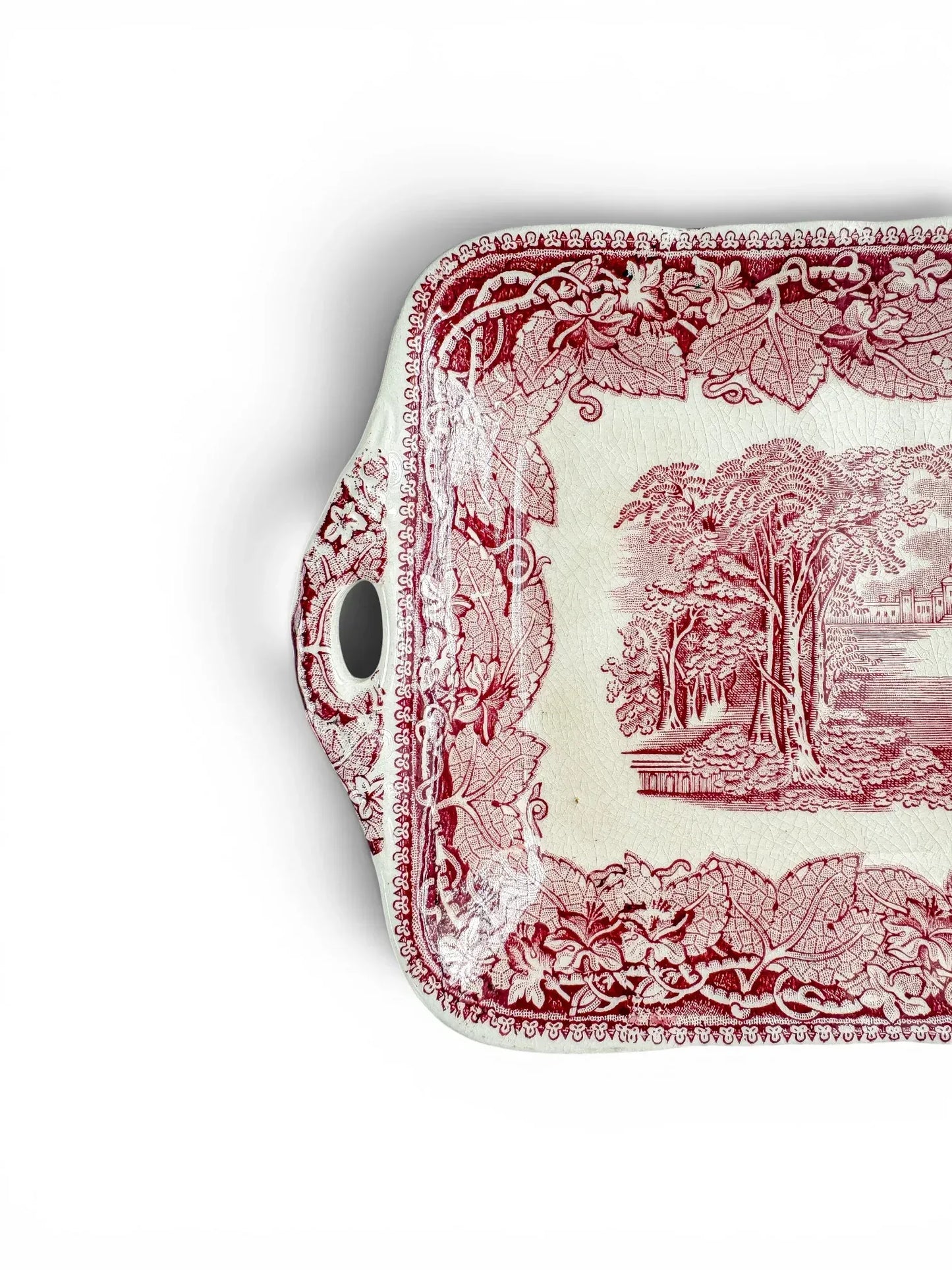 Detail of the left handle and corner of the vintage Mason’s Vista tray, with red floral transfer decoration and visible crazing.