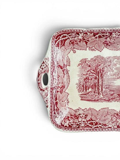 Detail of the left handle and corner of the vintage Mason’s Vista tray, with red floral transfer decoration and visible crazing.