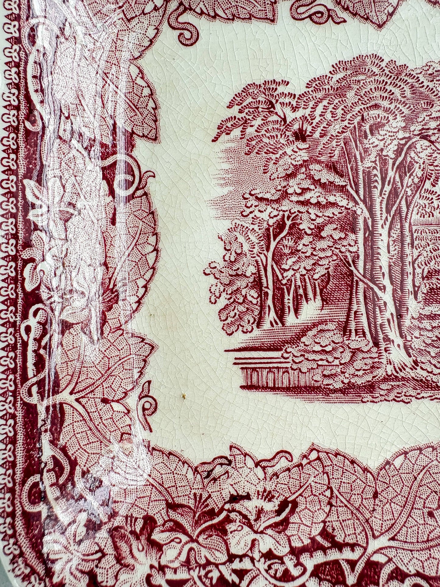 Close-up of the Mason’s Vista transferware surface showing fine glaze crazing, light staining and wear beside the scenic decoration.