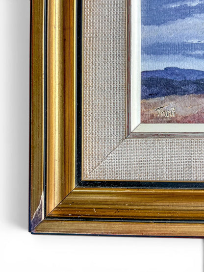 A close-up of the bottom-left corner of a mid-century gilt frame isolated on a white background. The shot details the textured fabric liner, a black inner border accent, and minor chipping on the outer gold edge, showing signs of vintage wear.