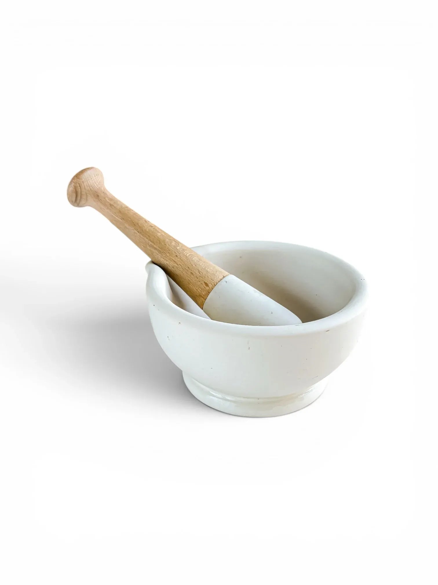 A vintage Milton Brook size 2 vitrified porcelain mortar and pestle with a natural beechwood handle, shown at a three-quarter angle on a crisp white background.