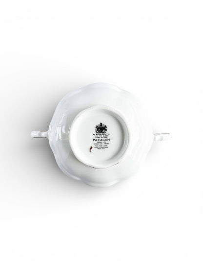 Bottom view of white Paragon fine bone china teapot with maker’s mark and royal crest on white background