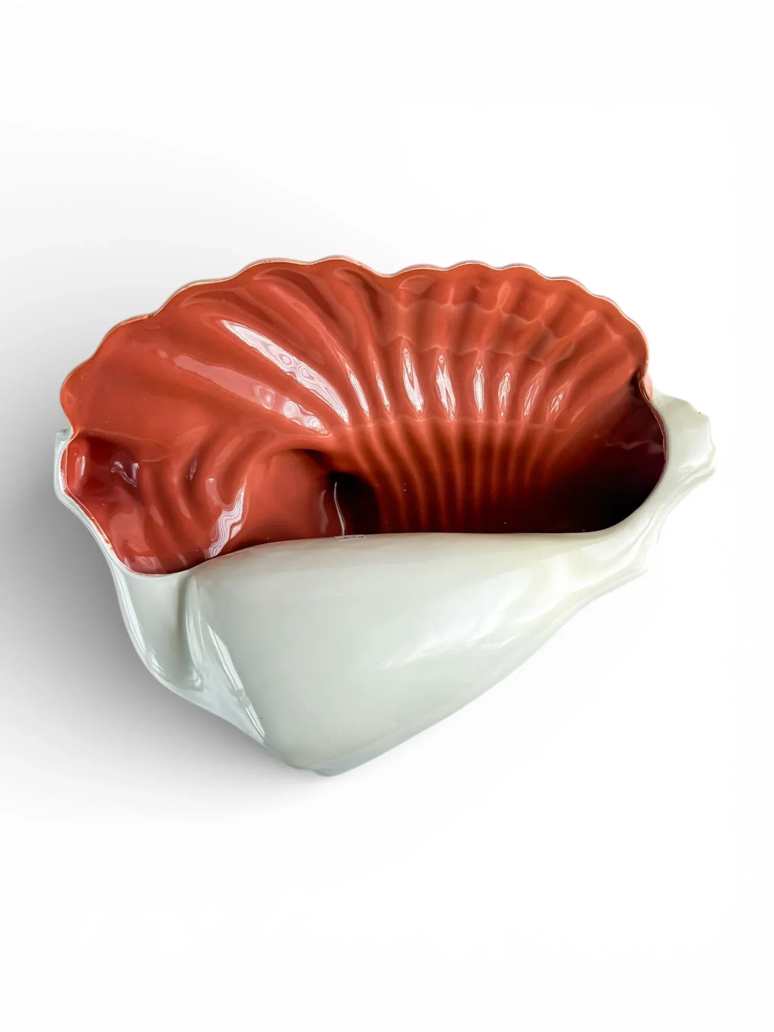 Vintage shell-shaped porcelain bowl with white exterior and glossy orange interior