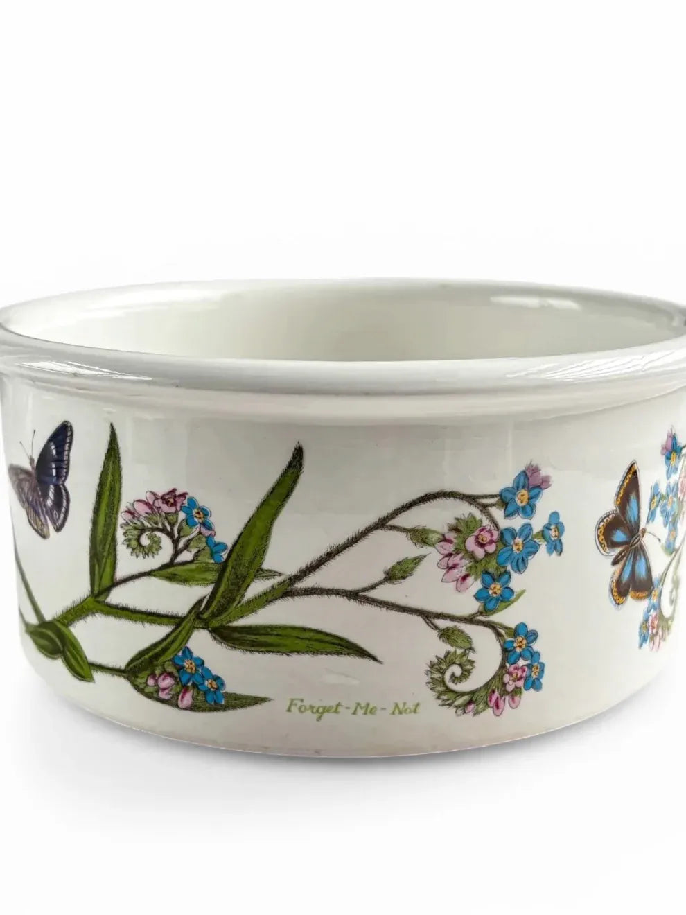 Ceramic bowl with floral and butterfly design on a white background
