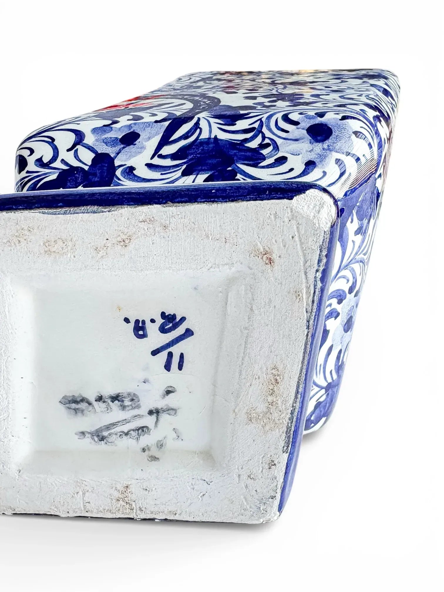 Bottom view of a blue and white porcelain vase with floral patterns and maker's marks