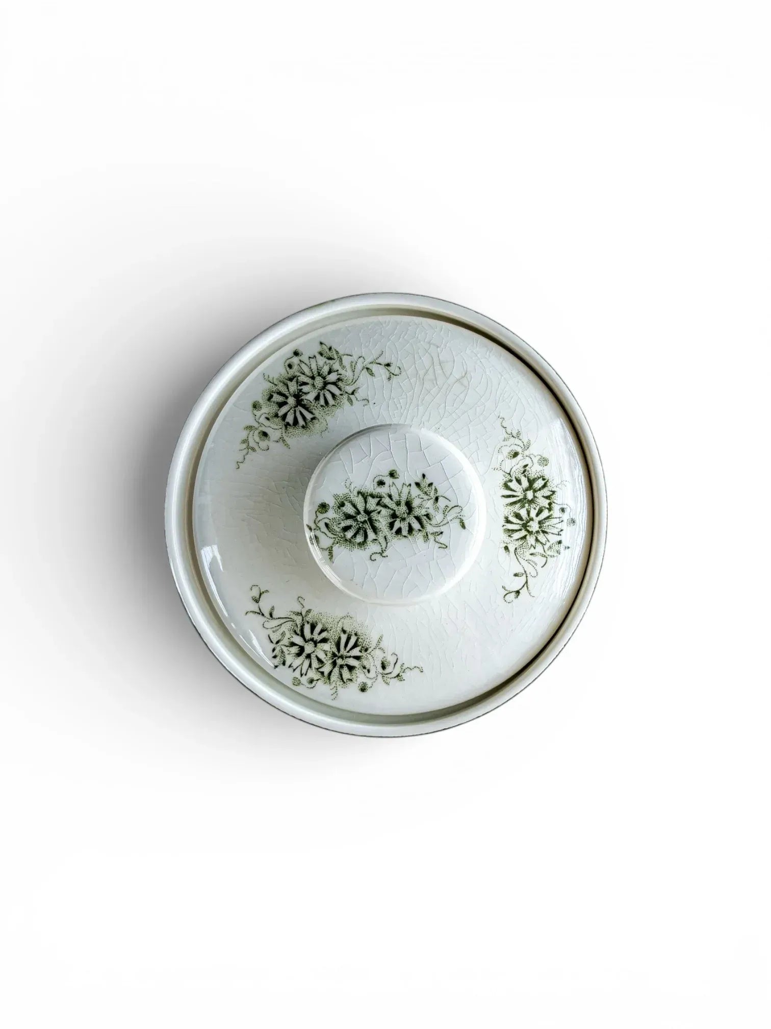 Top-down view of the Grön Anna sugar bowl lid, showing fine crazing and the central green floral motif.