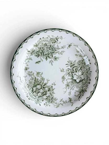 Top-down view of a Rörstrand Grön Anna dinner plate, featuring a deep green Neo-Rococo floral pattern and scalloped rim on a white flintware base.