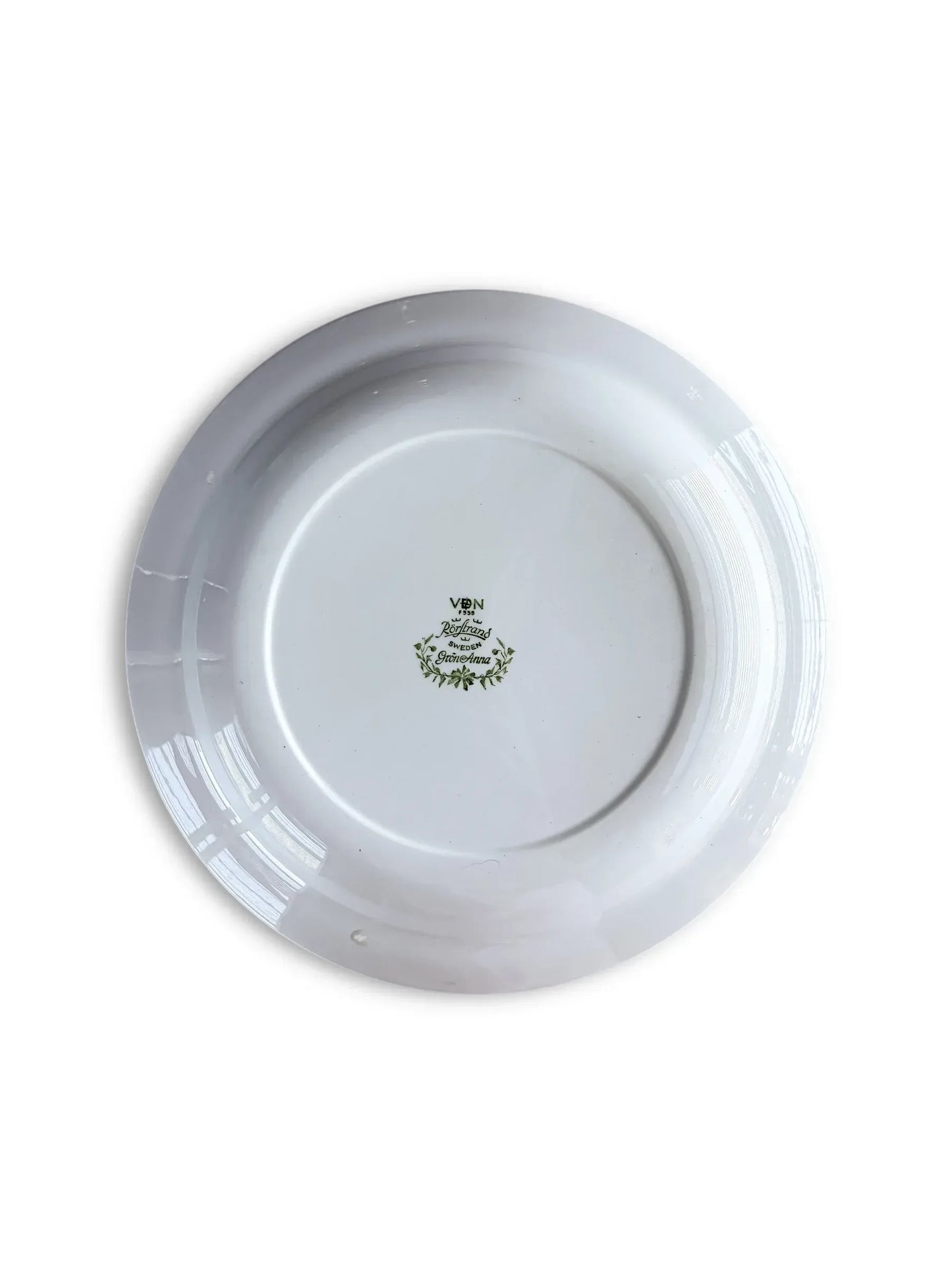 Underside of a Rörstrand Grön Anna plate showing the official green backstamp with the VDN F555 quality code and "Made in Sweden" markings.