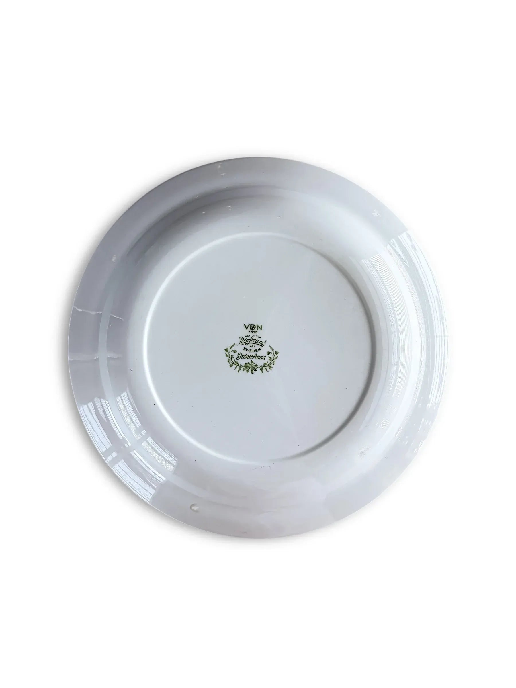 Underside of a Rörstrand Grön Anna plate showing the official green backstamp with the VDN F555 quality code and "Made in Sweden" markings.