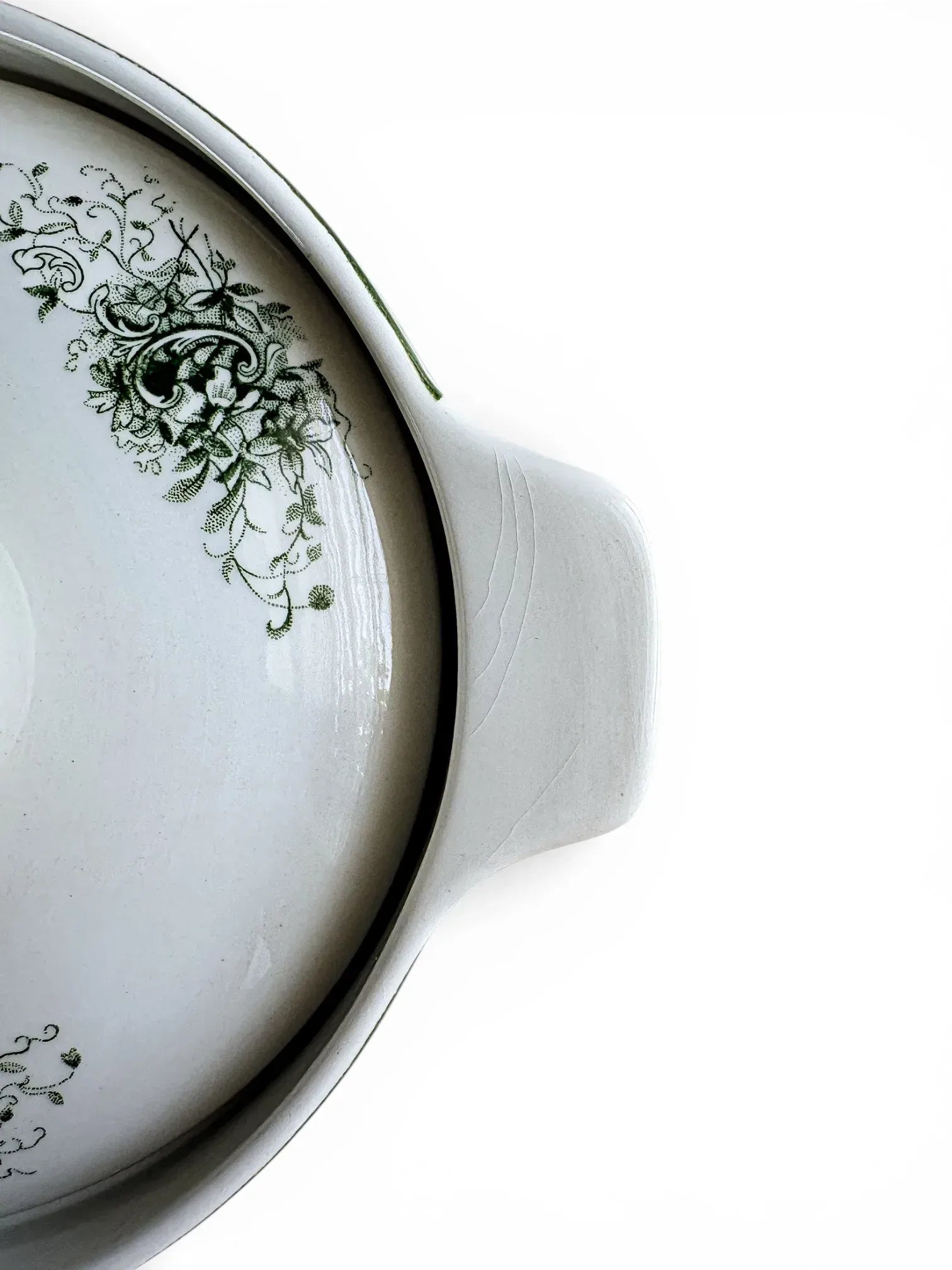 Detailed view of vintage crazing patterns on the integrated handle of a Rörstrand vegetable server.