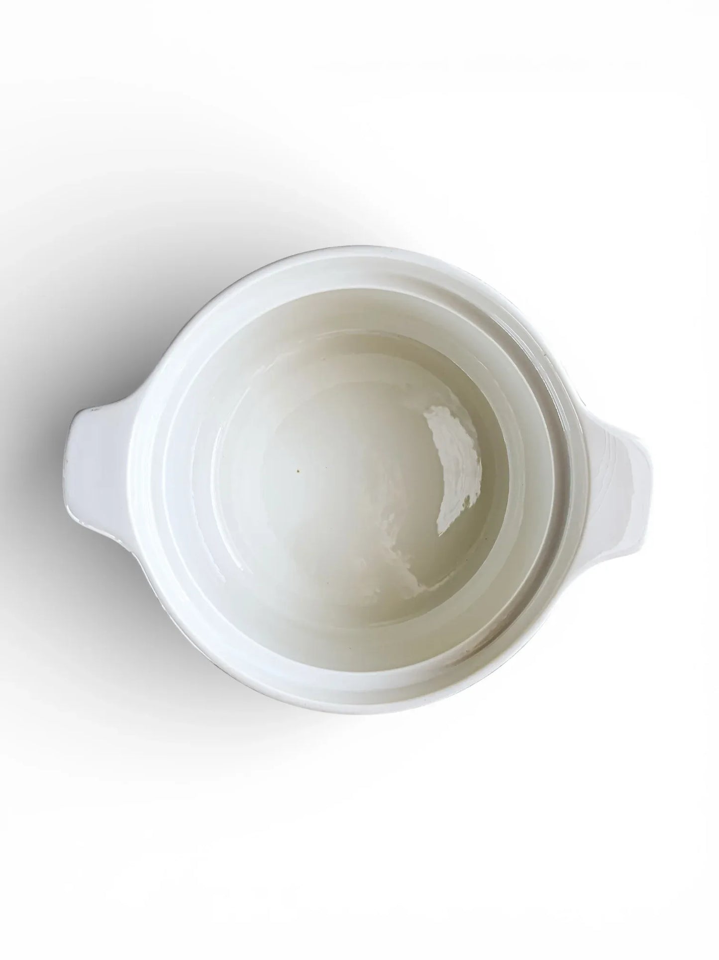 A top-down look into the open Rörstrand tureen, showcasing a clean, bright white glazed interior suitable for serving hot side dishes.