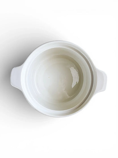 A top-down look into the open Rörstrand tureen, showcasing a clean, bright white glazed interior suitable for serving hot side dishes.