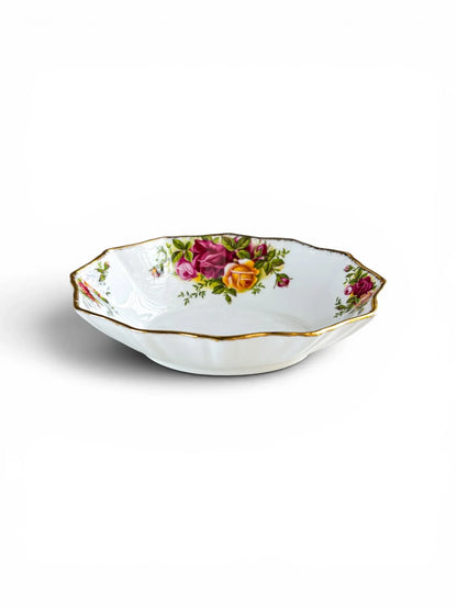 A side-angle view of a shallow Royal Albert Old Country Roses sweet meat dish, showing its fluted Montrose shape and 3.5 cm depth. The stippled 22ct gold rim and floral interior motifs are clearly visible against a crisp white background.