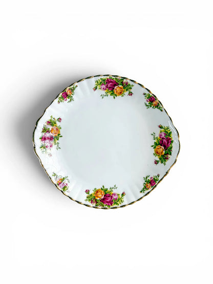 Top-down full view of a vintage Royal Albert Old Country Roses fine bone china cake serving plate on a white background, showing the fluted rim, gold stippled edge, and floral clusters.