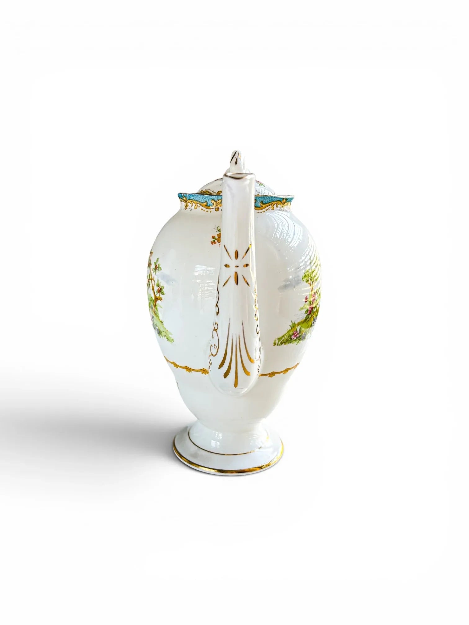 Front-facing view of the coffee pot focusing on the elongated, fluted spout. The shot highlights the intricate, vertical gold scrollwork and accents running down the length of the white porcelain spout.