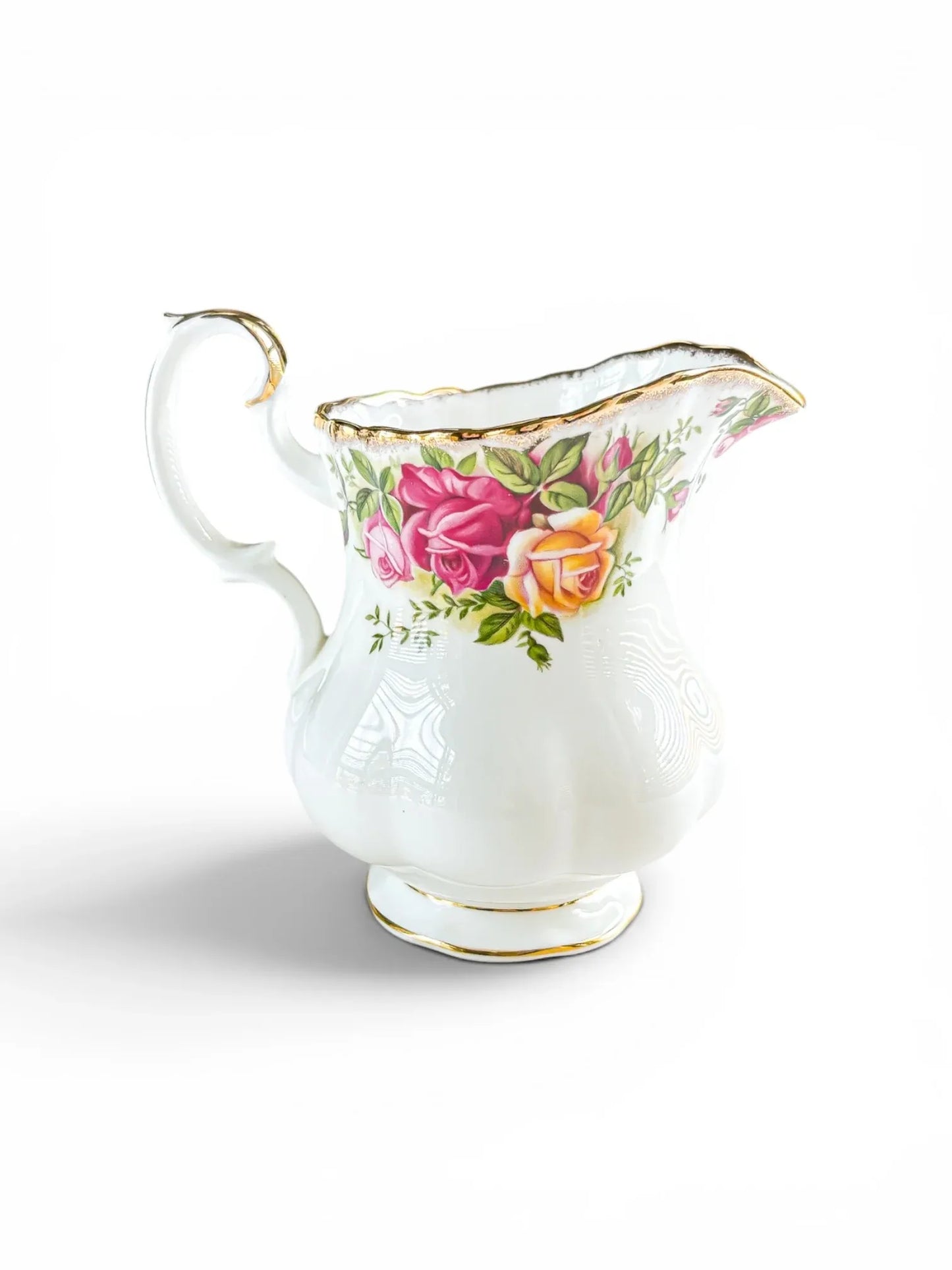 Opposite side profile of the Royal Albert Old Country Roses milk jug, showcasing the full cluster of deep burgundy and peach tea roses with intact 22-carat gold stippling on the scalloped rim.