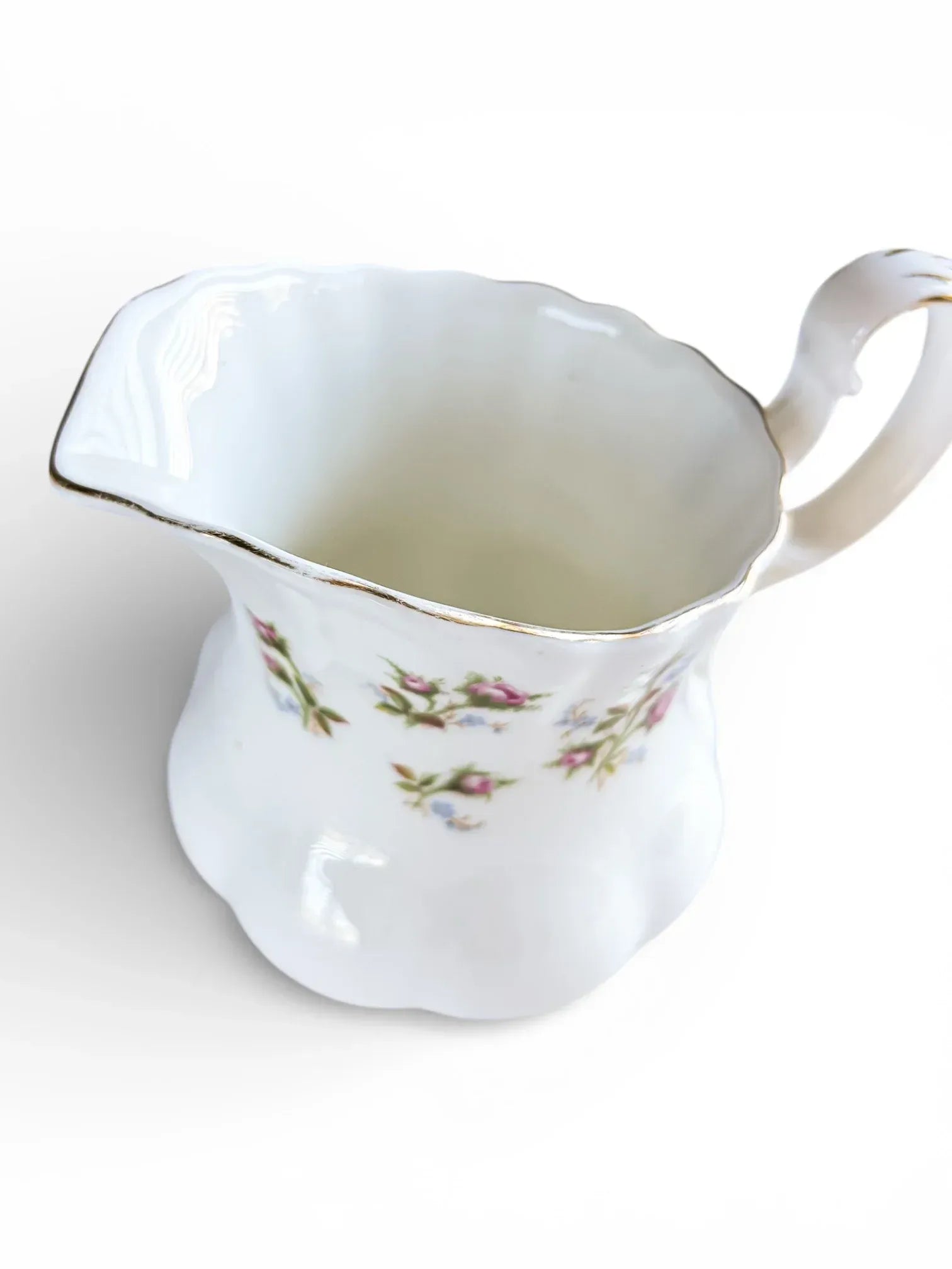 Top-down view of the Winsome creamer showing the clean white interior and the scalloped, gold-trimmed rim.