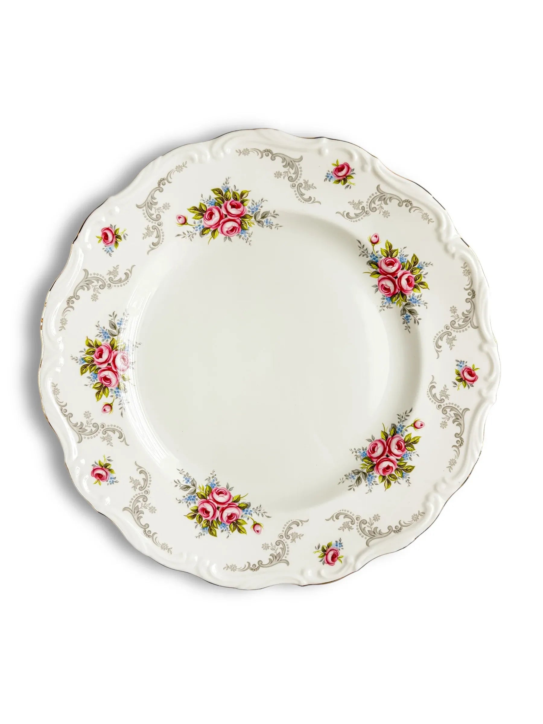 Vintage porcelain plate with pink floral design and ornate silver detailing