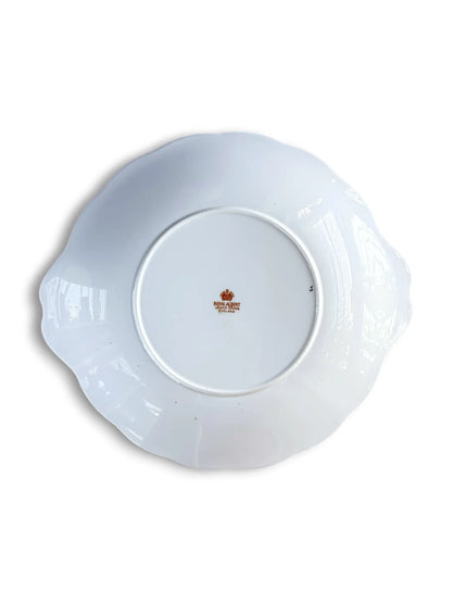 The underside of the Royal Albert Heirloom cake plate, showing the clean white porcelain base and the official orange-toned Royal Albert Bone China England backstamp in the centre.