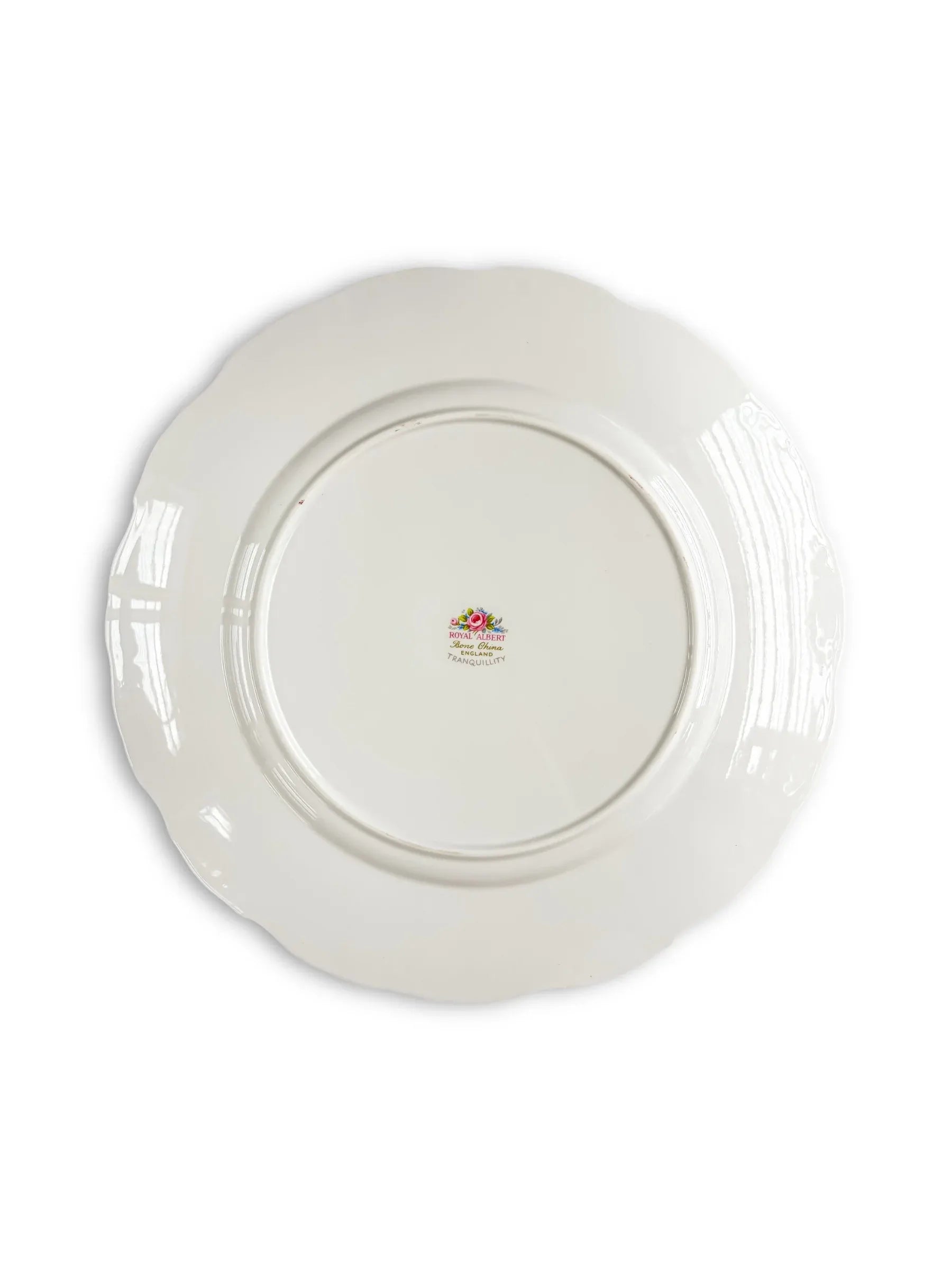 Back of vintage white porcelain plate with floral hallmark, scalloped edge, collectible tableware