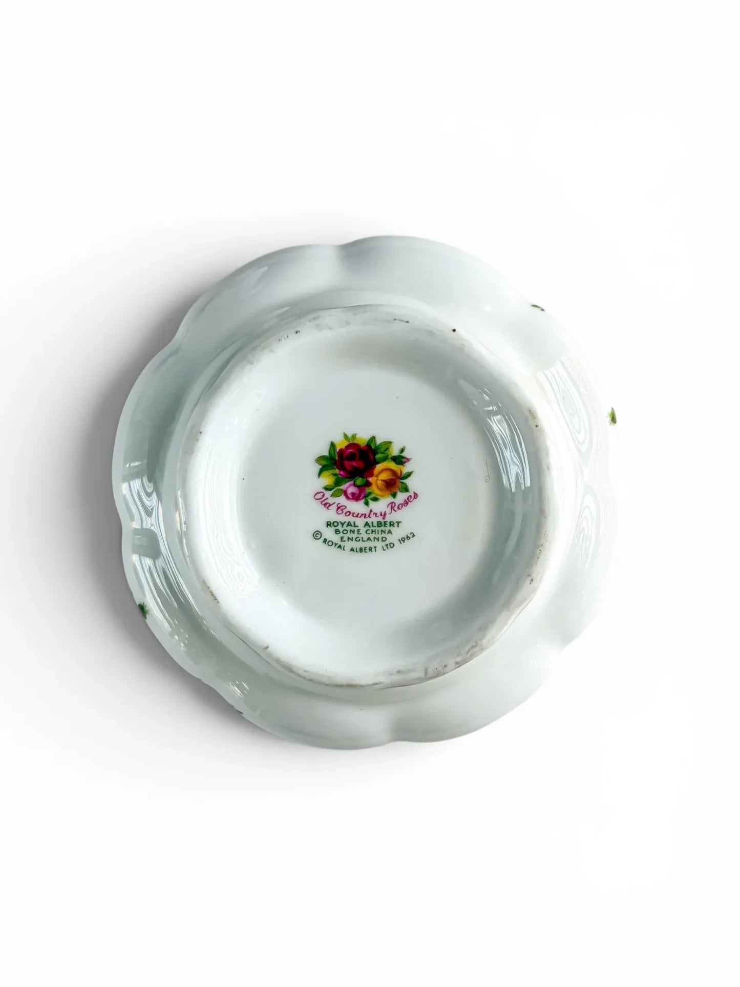 Close-up of the underside of the Royal Albert Old Country Roses open sugar bowl base, displaying the multi-coloured floral backstamp certifying first-quality manufacture in England.