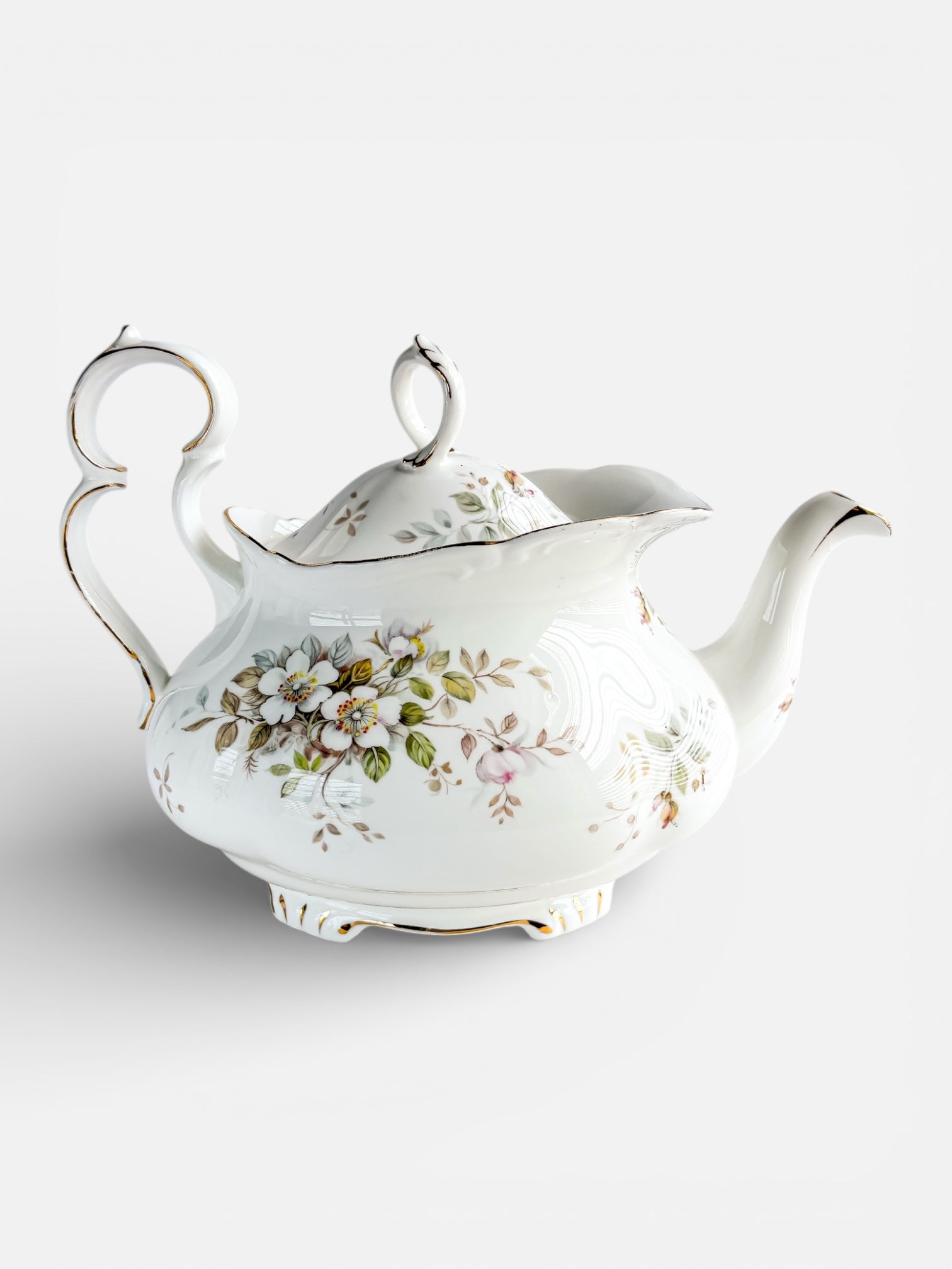 Elegant white porcelain teapot with floral design and gold accents, vintage collectible tableware