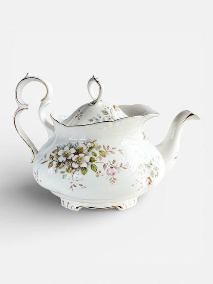 Elegant white porcelain teapot with floral design and gold accents, vintage collectible tableware
