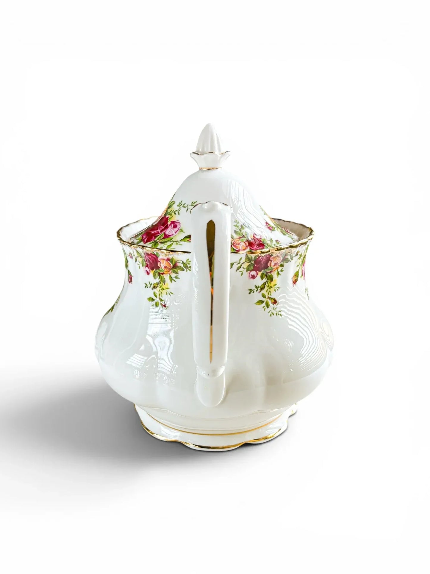 Rear view of the large Royal Albert Old Country Roses teapot, showing the details of the white porcelain split-twisted handle and its hand-applied 22-carat gold spine accent.