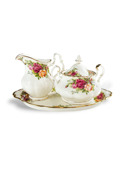 A curated three-piece vintage Royal Albert Old Country Roses tea service set in the Avon shape, including a creamer jug and covered sugar bowl displayed on an oval serving tray.