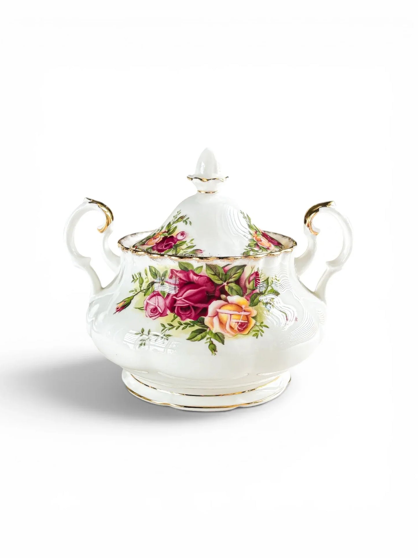 Front view of a vintage Royal Albert Old Country Roses covered sugar bowl in the Avon shape, showing its low-slung body, dual rococo handles, and matching lid with a gold-tipped finial.