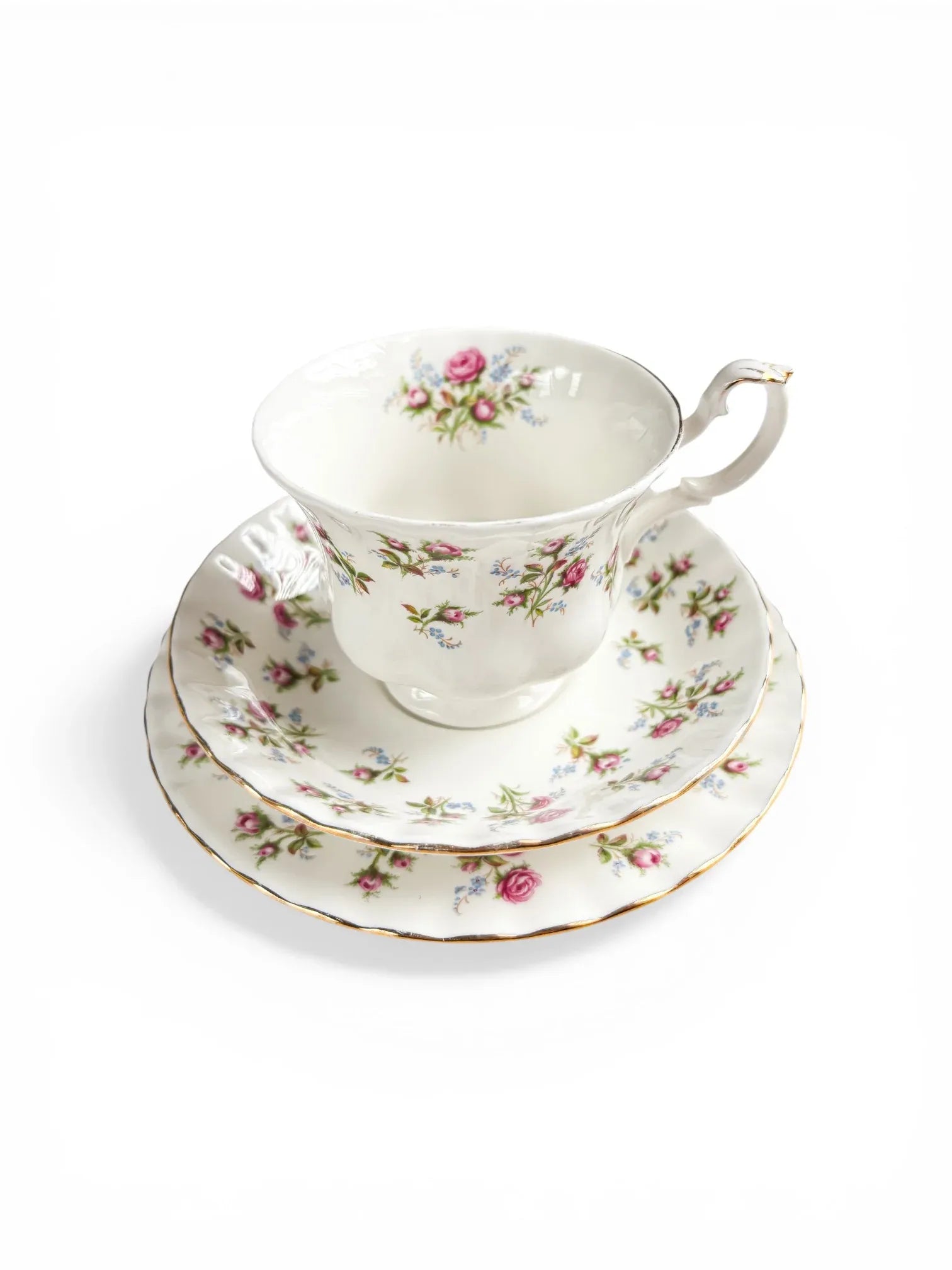 A stacked view of the Royal Albert Winsome trio highlighting the delicate rose pattern despite the vintage wear on the gold edges.