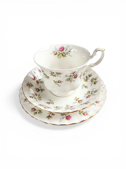 A stacked view of the Royal Albert Winsome trio highlighting the delicate rose pattern despite the vintage wear on the gold edges.
