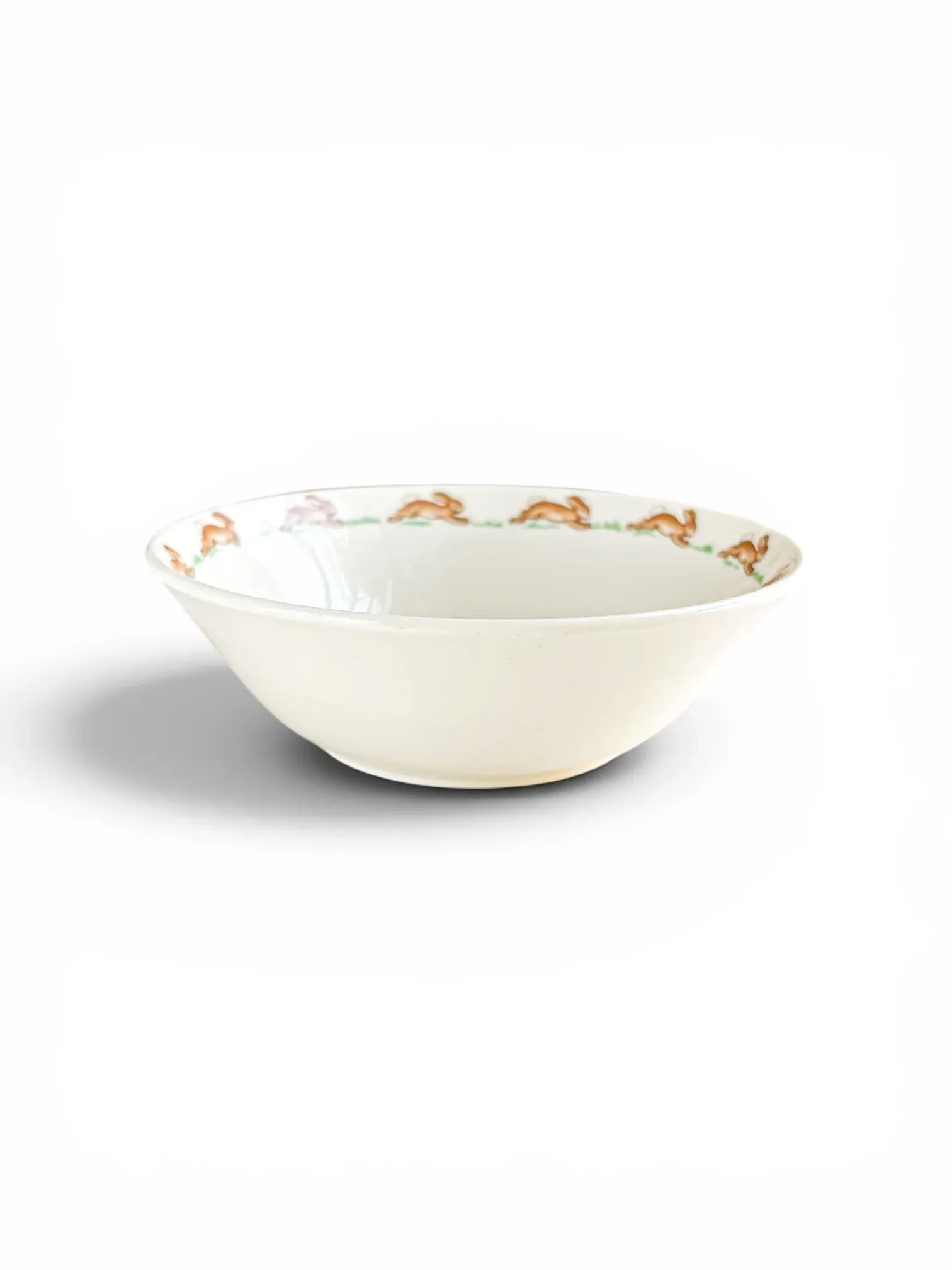 Side profile view of a white English fine bone china Bunnykins cereal bowl.