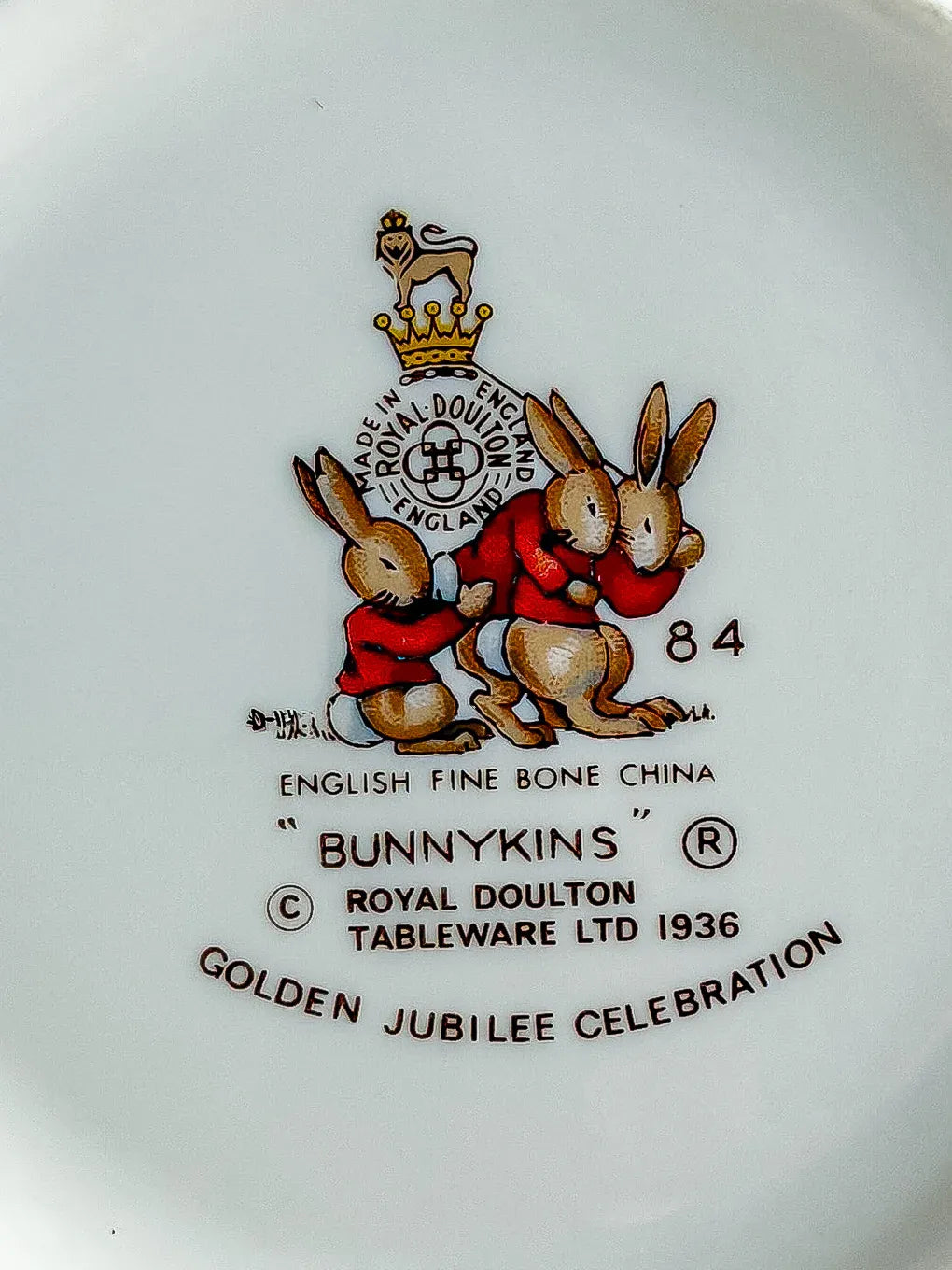 Detailed view of the 1984 Golden Jubilee Celebration Royal Doulton stamp.