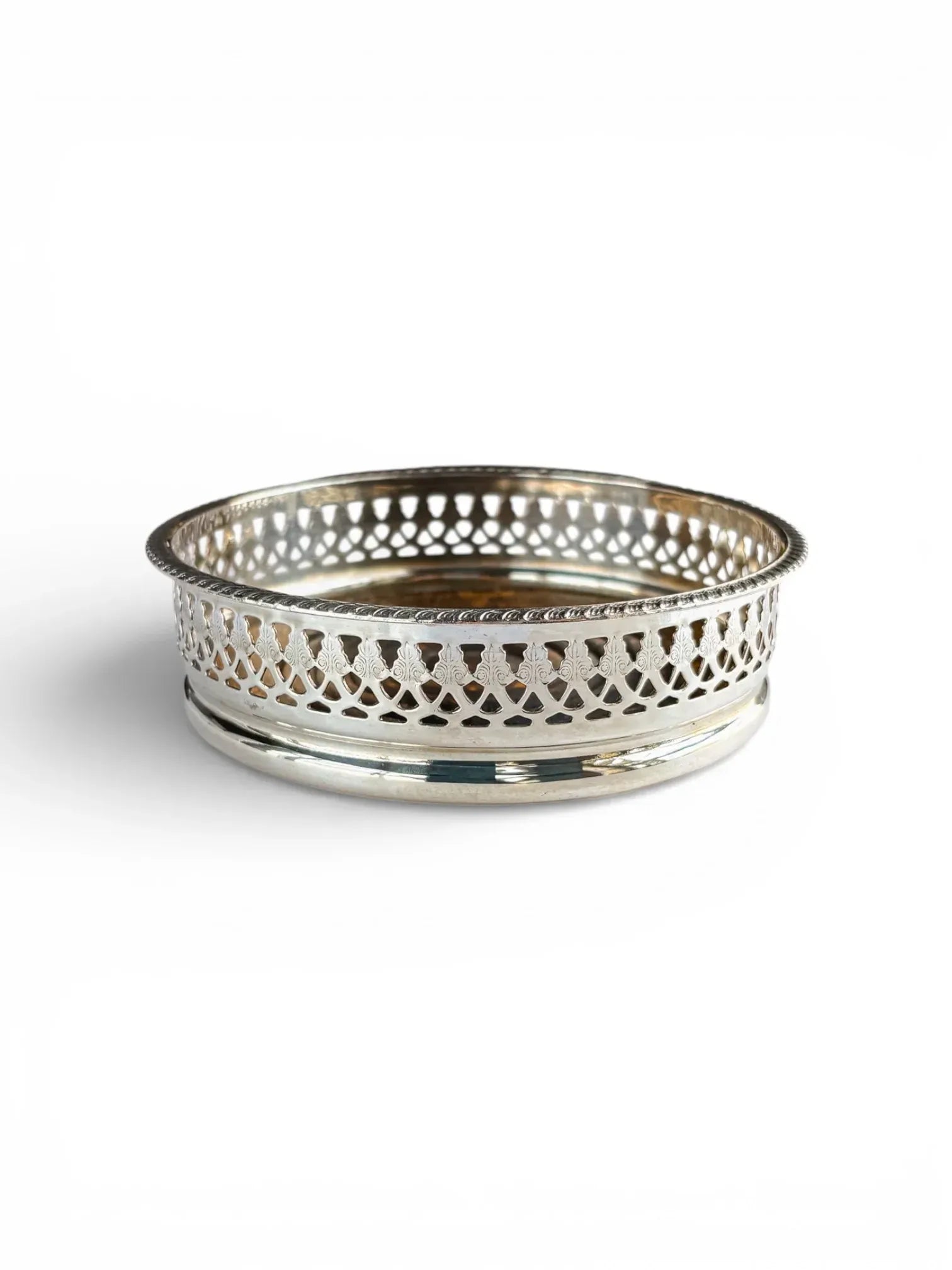 Side view of a vintage EPNS silver-plated wine coaster showcasing a decorative pierced gallery and classic beaded edge.
