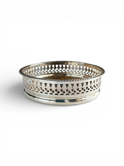Side view of a vintage EPNS silver-plated wine coaster showcasing a decorative pierced gallery and classic beaded edge.