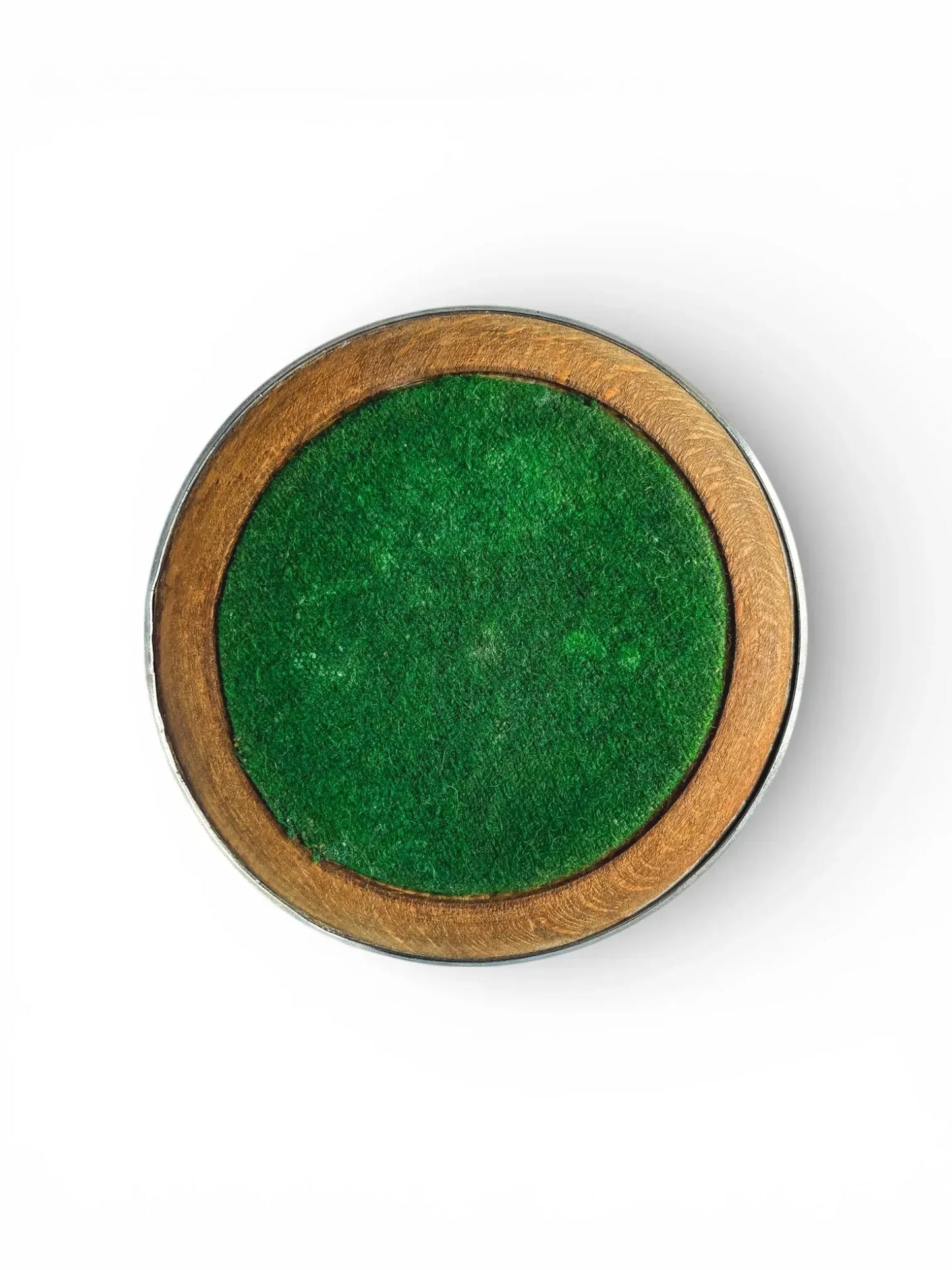 Underside of a vintage wine coaster showing the protective green baize felt centre and circular wooden base.