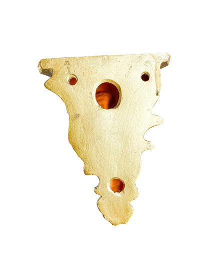 Vintage brass tableware accent piece with ornate cutouts on white background