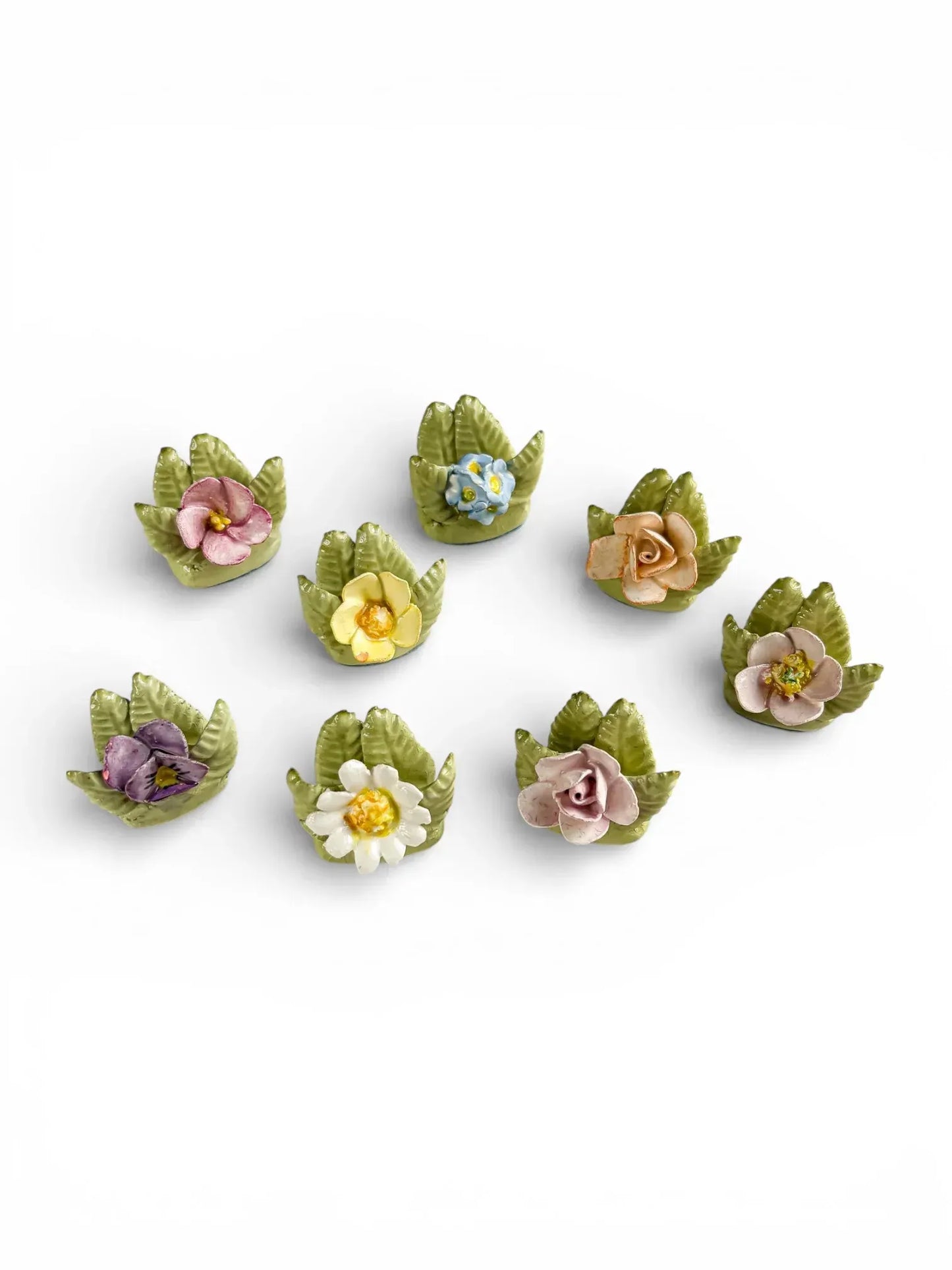 Grouping of 8 unique vintage porcelain botanical place card holders featuring pansies, roses, and primroses.