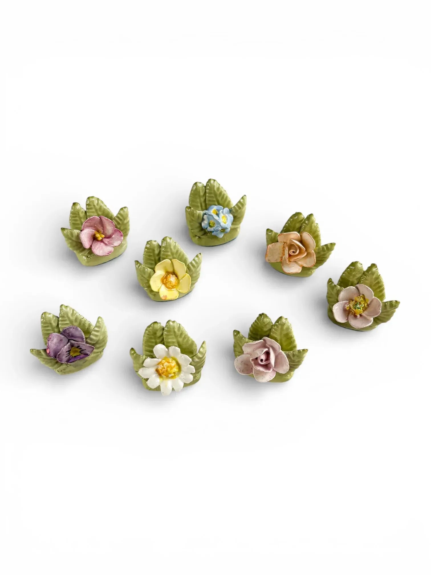 Grouping of 8 unique vintage porcelain botanical place card holders featuring pansies, roses, and primroses.