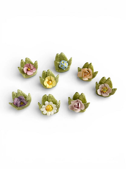 Grouping of 8 unique vintage porcelain botanical place card holders featuring pansies, roses, and primroses.