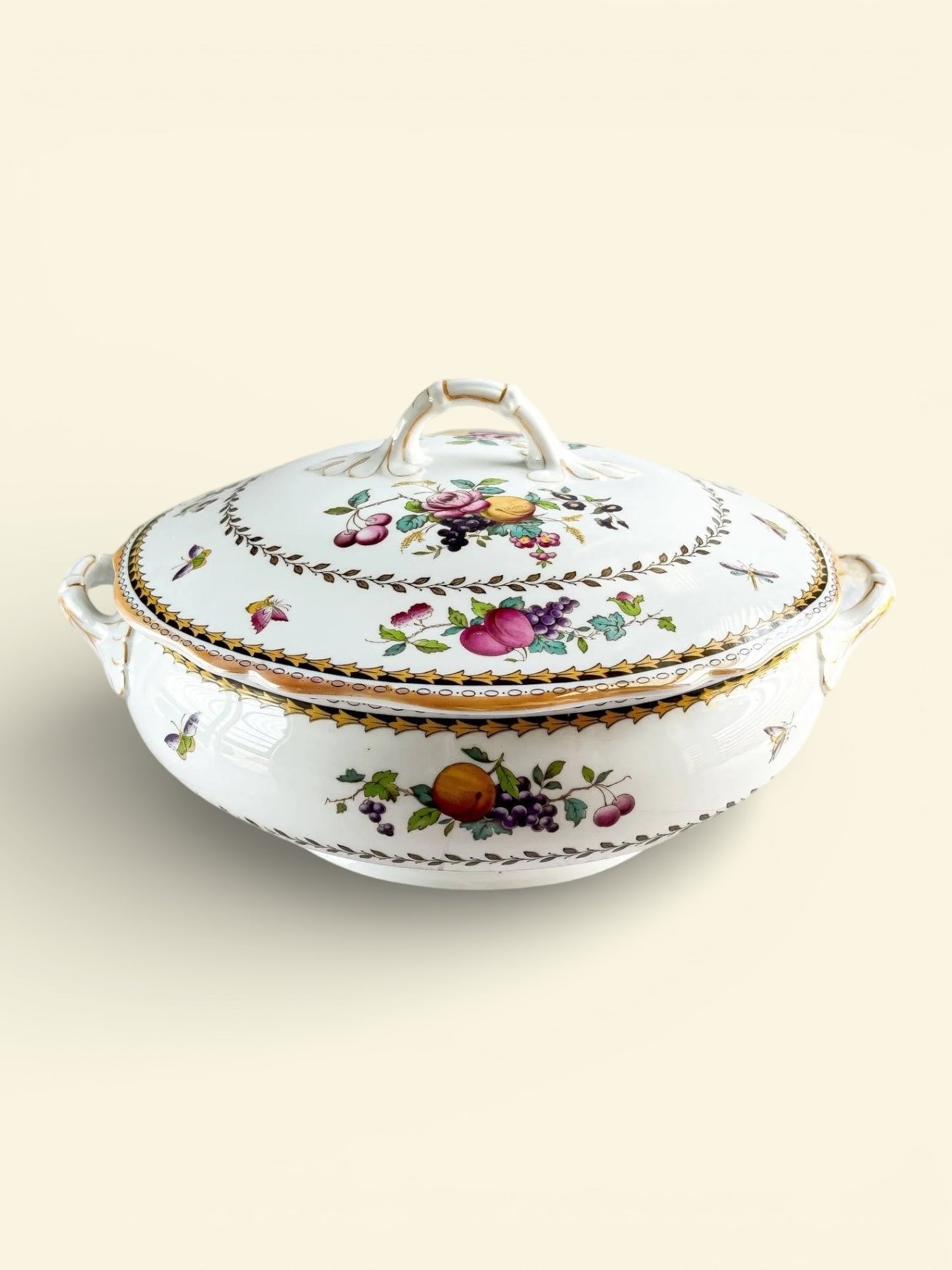Vintage porcelain covered serving dish with fruit and floral patterns and gold trim